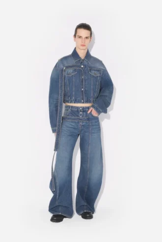 De blå denimjeansene med stropp
