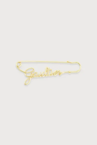 Den gullfargede Gaultier-sikkerhetsnålen